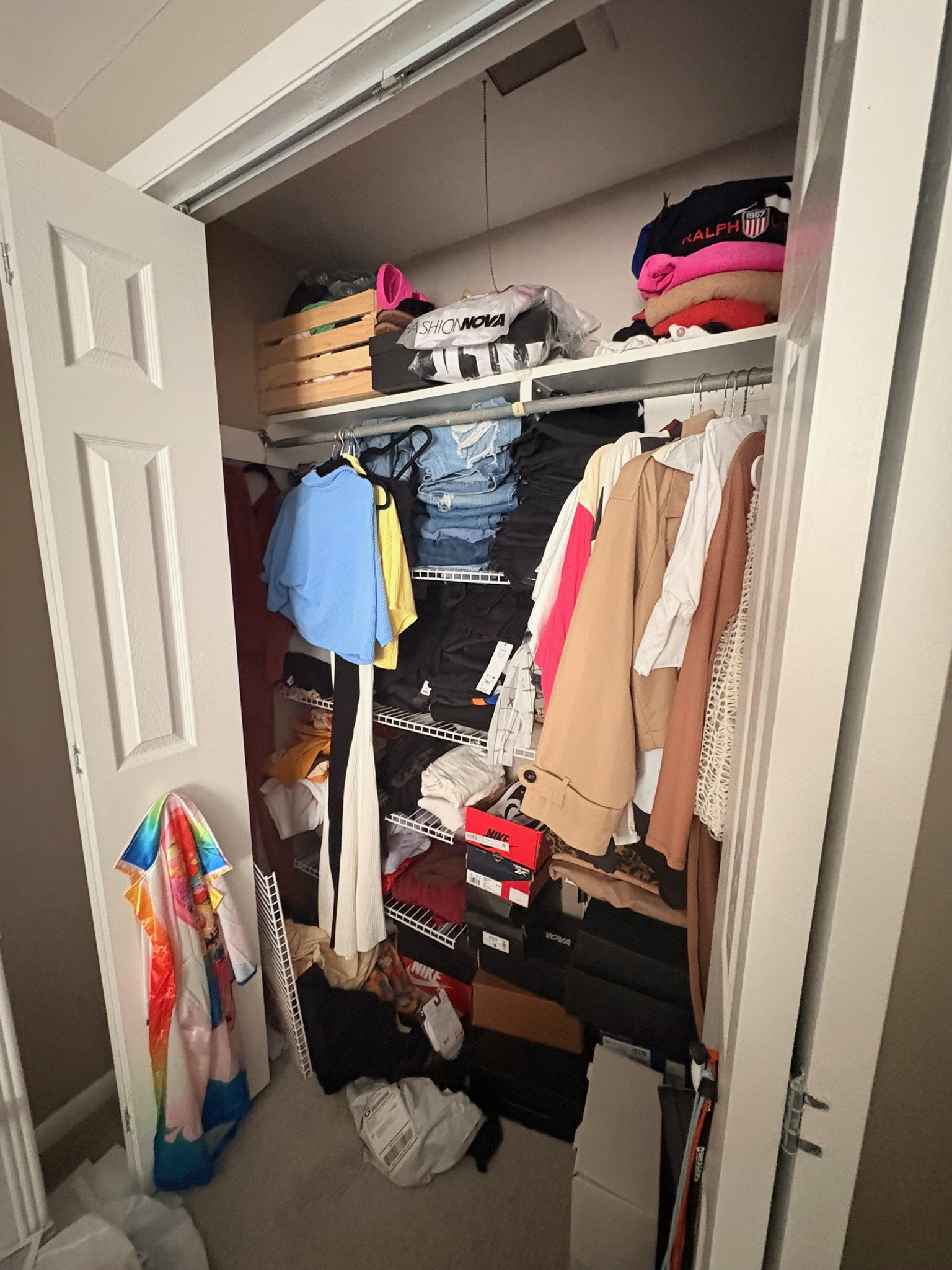 Packed bedroom closet before a Get Rewardrobed reset